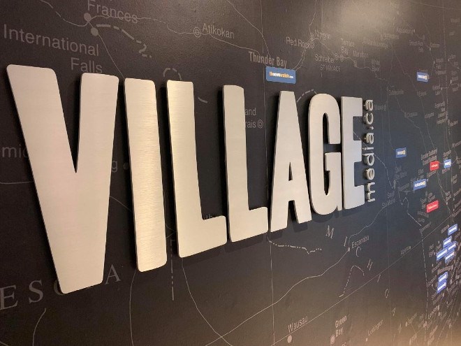Village Media sign