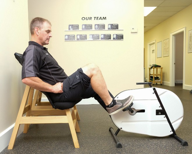 André Riopel demonstrates how to use the Viscus, a therapeutic pedalling machine he invented to help speed healing and improve mobility in patients. (Photo supplied)