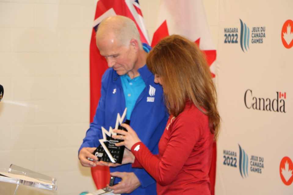 Kelly-Ann Paul, Canada Games president and CEO, presents board chair Doug Hamilton with a reminder of his role in the success of the event.