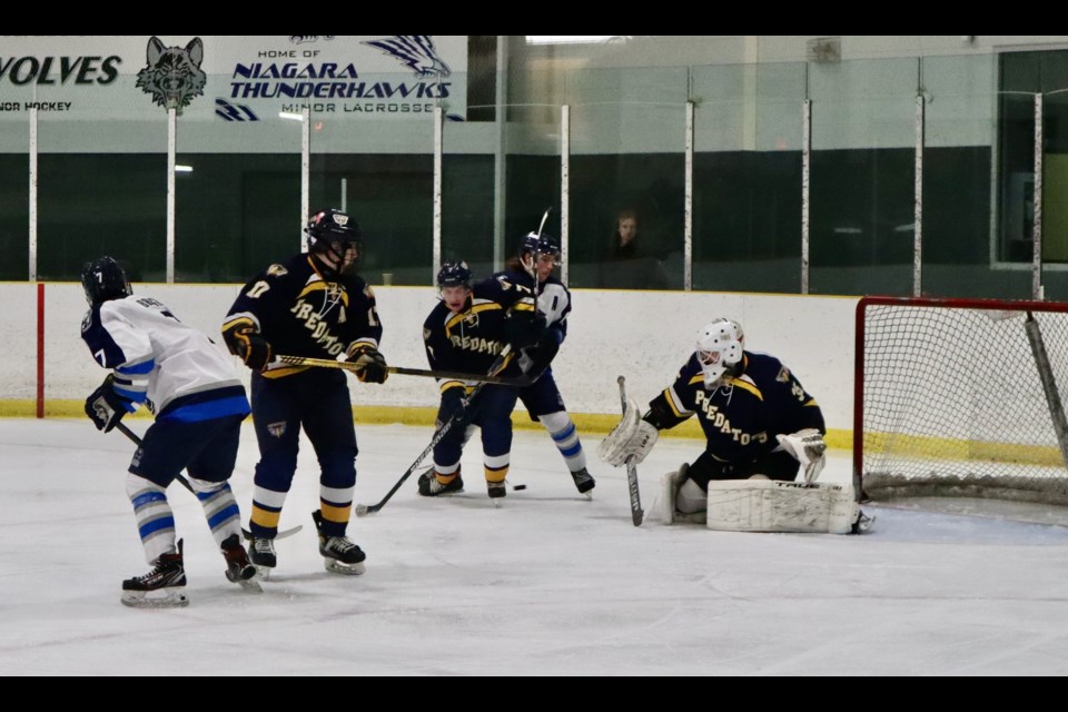 Preds defenders Logan Baillie and Guy Manco help goalie Zane Clausen defend the net.