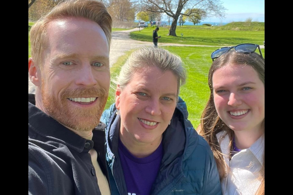 Amazing Race Canada host Jon Montgomery with Tracey Frena and her daughter Rachel, the Niagara Golf Course and Fort Mississauga in the background.