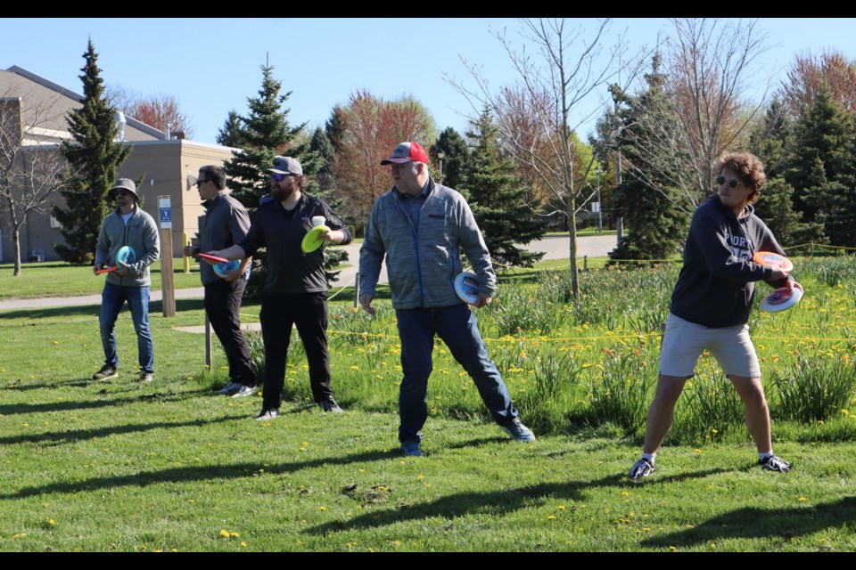 Grimsby Chamber of Commerce members giving disc golf a try. 