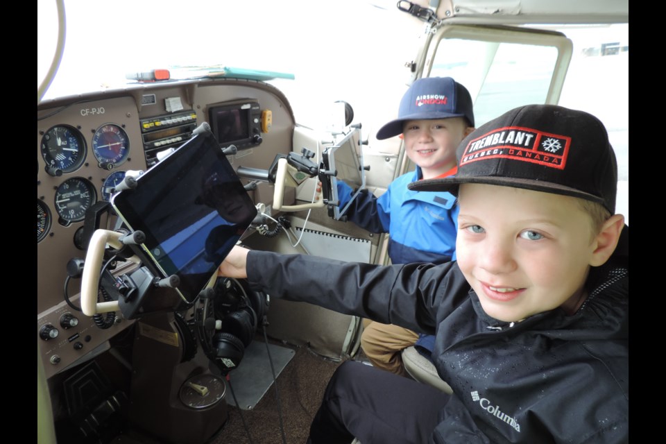Evan and Sam Syer get a tour of the Search and Rescue plane at the Niagara District Airport open house.       