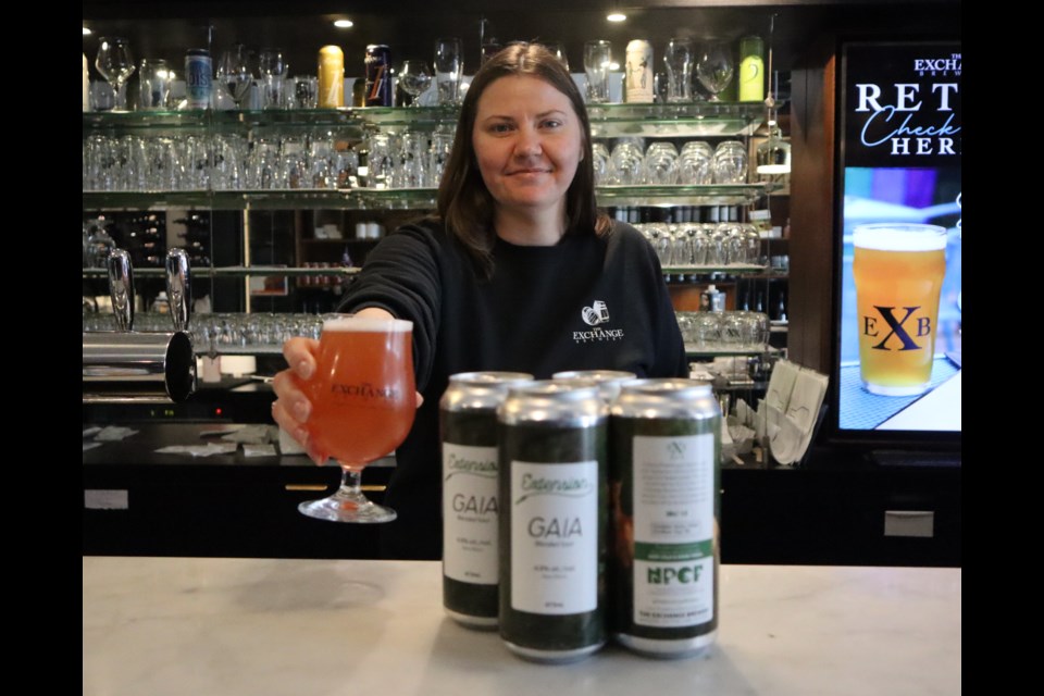 Kathryn Dodington offers up a glass of Gaia beer at The Exchange Brewery's taproom. 