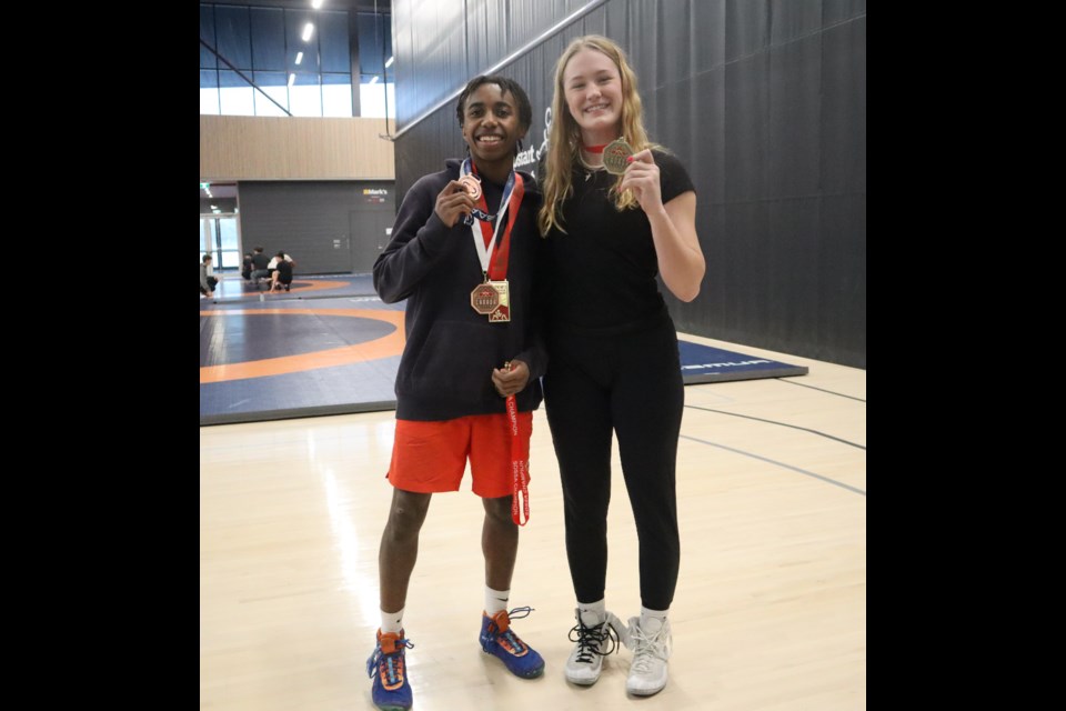 Ezekiel Ivri and Charlotte Bowslaugh show off the hardware they won in Ottawa last month at the National Team Wrestling Trials. 