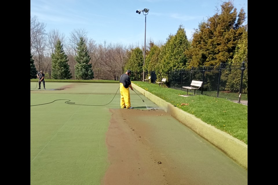 A crew was power washing the synthetic bowling green at the NOTL Lawn Bowling Club Tuesday. 