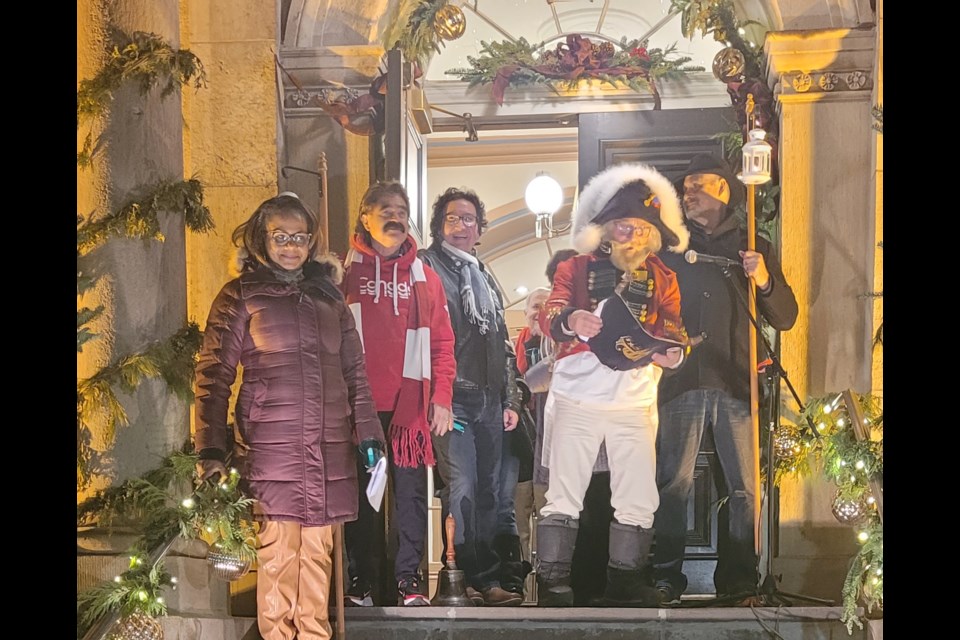 Athena Snyder is the first to have her candle lit at the Court House by Ceto Reid for the start of Friday’s Candlelight Stroll. Reid, an injured farmworker, was chosen to be the recipient of some of the funds raised, and to lead the stroll. (Penny Coles)