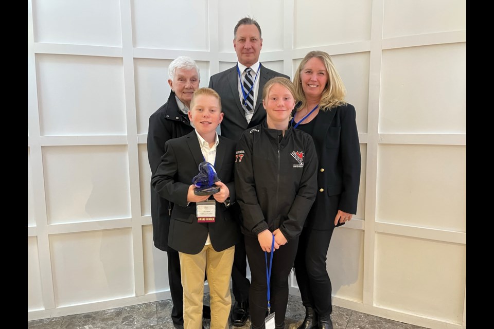 Jayden Polgrabia with his award, grandmother Millie Polgrabia, parents Mark and Caroline and sister Kaitlyn.