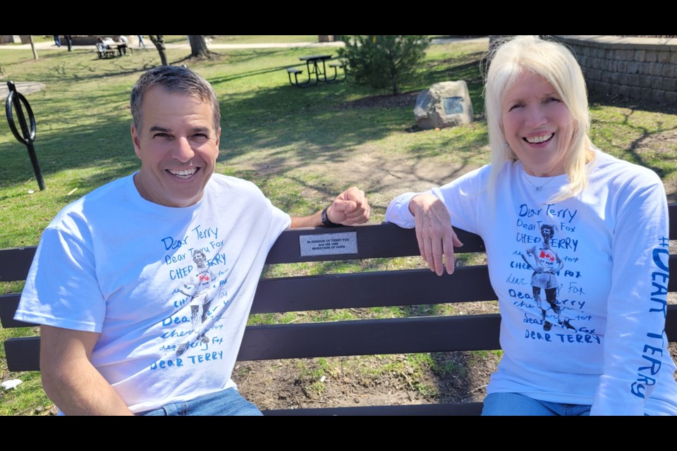 Joe Pillitteri and Joan King show off this year's Terry Fox T-shirts, designed by Ryan Reynolds and called Dear Terry, representing the many hand-written letters he received during his run.