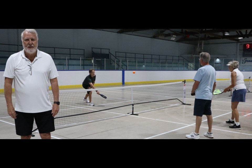John Hindle in the foreground with club members (left to right) Timo Kontkanen, Darryl Rutt and Roline Rzepka warming up on the Centennial Arena courts.