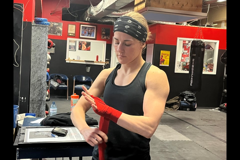 Mckenzie Wright wraps her hands in preparation for a recent workout at City Boxing Club in Niagara Falls. 