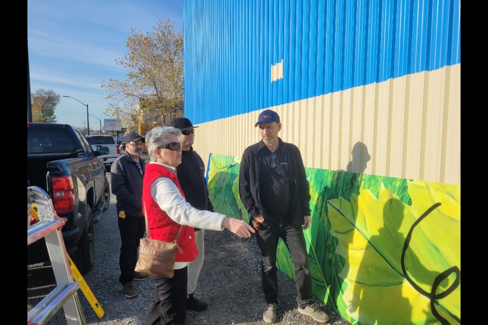 Shawn Fleming, Frank Doolittle and Terry Fleming with Gail Kerr before the Virgil mural installation work began Thursday morning.