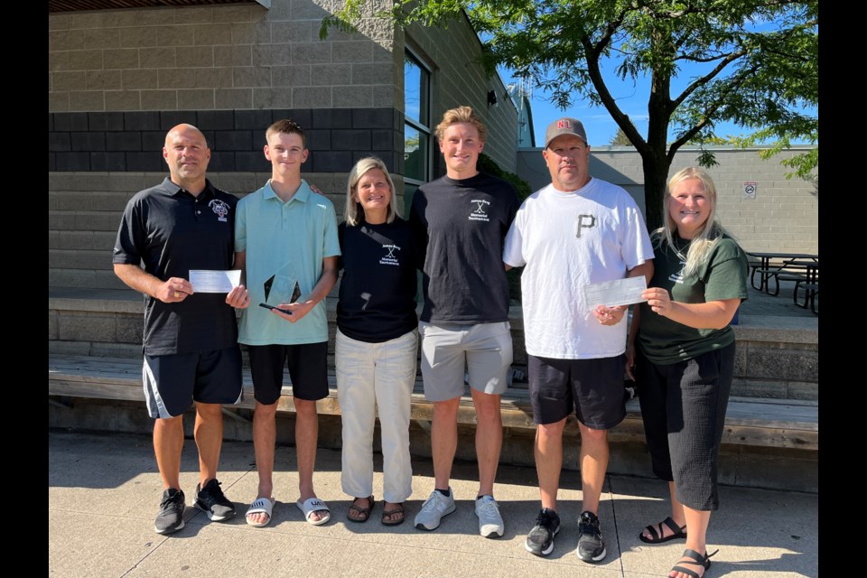 The Berg family presents the proceeds from their tournament to Sam Walker and the NOTL Wolves Minor Hockey Club.  L-R: Wolves vice president Joe Pagnotta, scholarship winner Sam Walker, Carolyn Berg, Mackenzie Berg, Wolves president Peter Flynn, Madison Berg