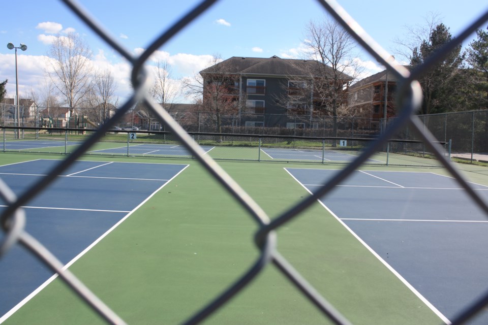 The outdoor pickleball courts at the Virgil sports park, with the Lambert's Walk condominium complex in the background. 