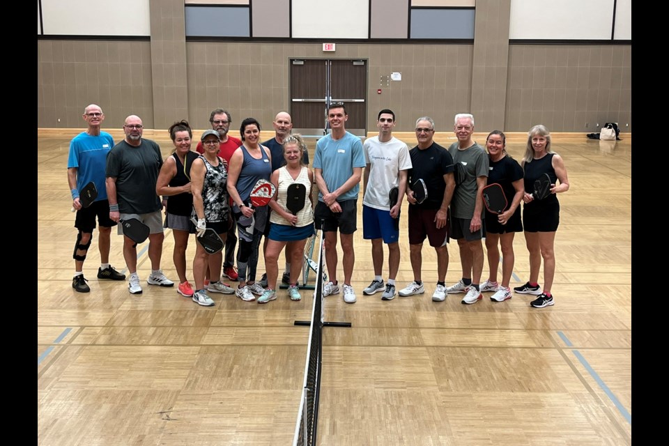 Twelve NOTL Club members from the skills session held Saturday afternoon pose with pros Mark Cleminson and Adam Eatock (9th and 10th from left).