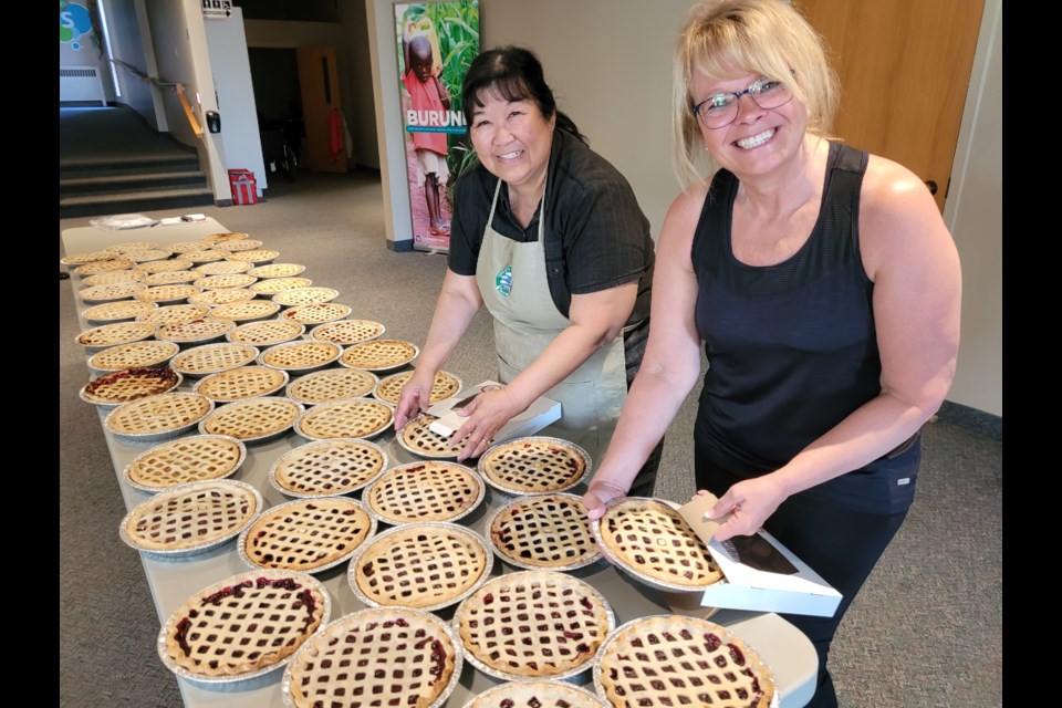 Dorothy Soo-Wiens and Luanne Kulchar boxed up pies that were baked Friday, cooled and delivered to New Hamburg by 5:30 for a lineup of people anxious to buy one. 