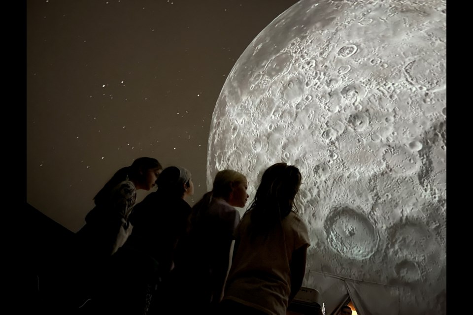 St. Davids Public School students Eileen, Tessa, Maya and Ena travel to the moon inside the Astronomy in Action portable planetarium. 