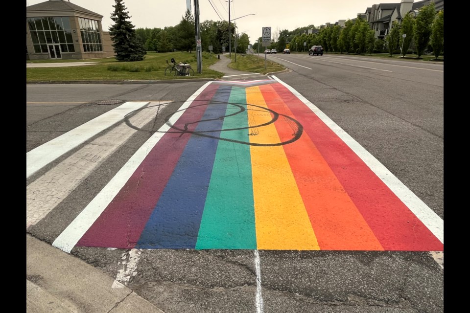 The Pride crosswalk after being defaced for the second time. 