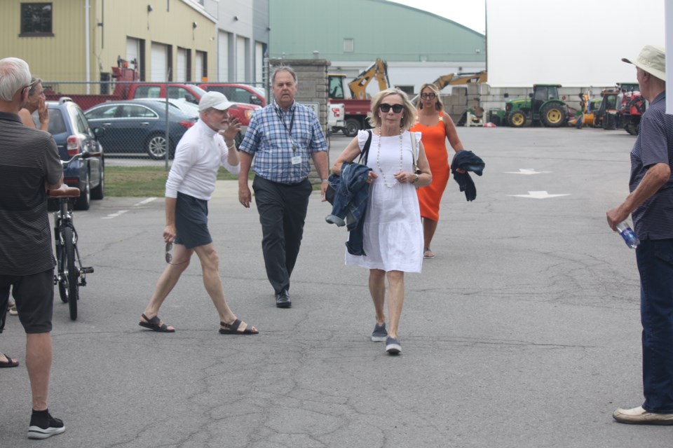 Coun. Wendy Cheropita, along with interim CAO Bruce Zvaniga and Coun. Maria Mavridis, walking through a crowd of protestors at town hall Tuesday. | All photos by Kris Dube