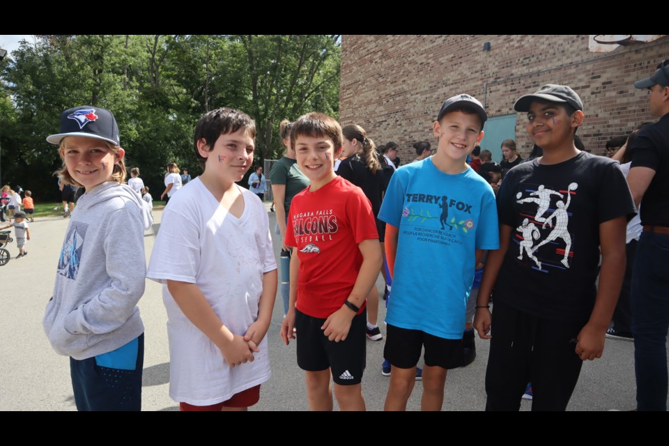 Charlie, Michael, Joey, Hunter and Husmain show off their temporary Terry Fox face tattoos