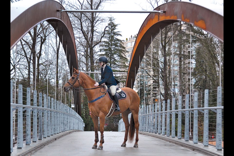 Emi Belluz and Dazzle, a 17-year-old quarter horse, take in the view as they cross the newly opened Spirit Trail bridge across Lynn Creek, Jan. 17, 2023 . Belluz rode Dazzle from the nearby North Shore Equestrian Centre where they compete in hunter/jumper events. | Paul McGrath / North Shore News