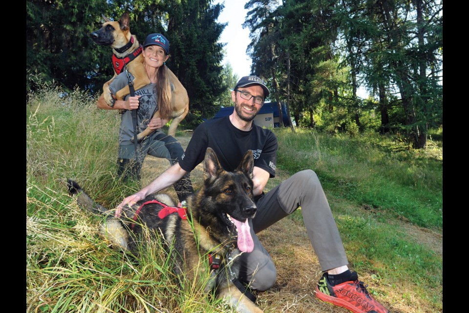 North Shore Rescue volunteers and dog trainers Ellie Lamb and Ryan Morasiewicz proudly show off the team's newest recruits – Dreki, a Belgian Malinois and Neiko, a German shepherd.