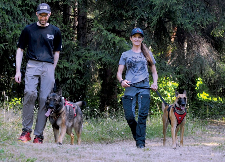 North Shore Rescue search dog trainer Ellie Lamb works with her dog Dreki, while Ryan Morasiewicz pairs with his canine partner Neiko.
