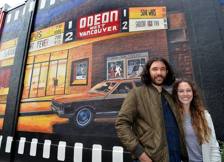 Emilie and Mike Fantuz look like they may be waiting for their show to start in front of their mural depicting the Odeon West Vancouver theatre in 1977.