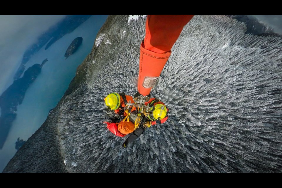 North Shore Rescue's long line team prepares to be lowered down to Christmas Gully in the West Vancouver backcountry, March 2, 2023. | North Shore Rescue