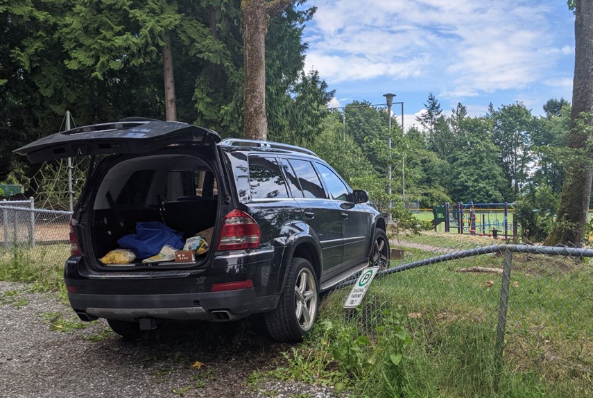 A West Vancouver parent's Mercedes SUV sits perched on the Cypress Park Elementary fence on Tuesday, June 15, 2021, after it was driven onto the schoolyard.