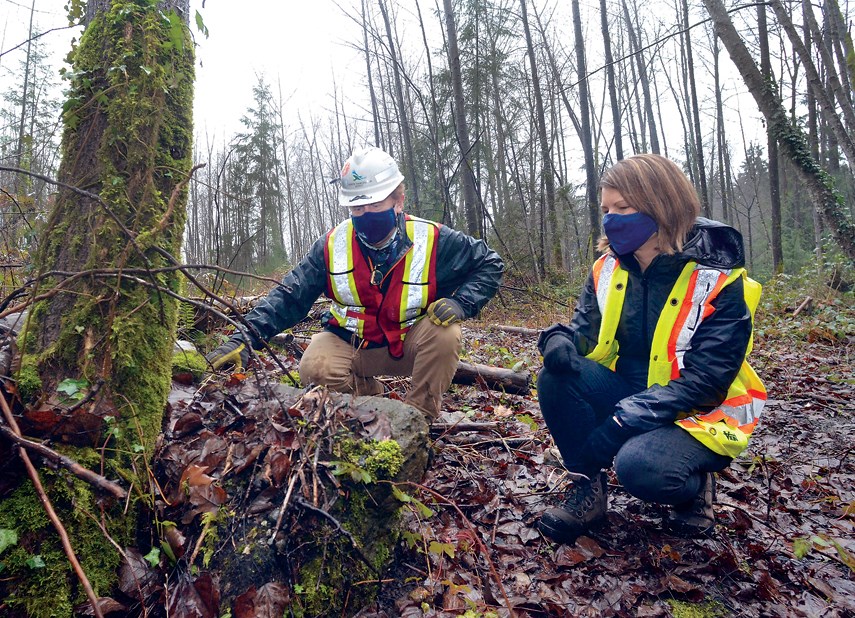 District of North Vancouver staff Nicola Chevallier and Mathew Schofield examine a chunk of concrete left at the district's former municipal dump site on Old Dollarton Road. The district is planning to dig up the dump and make room for a new fire hall.