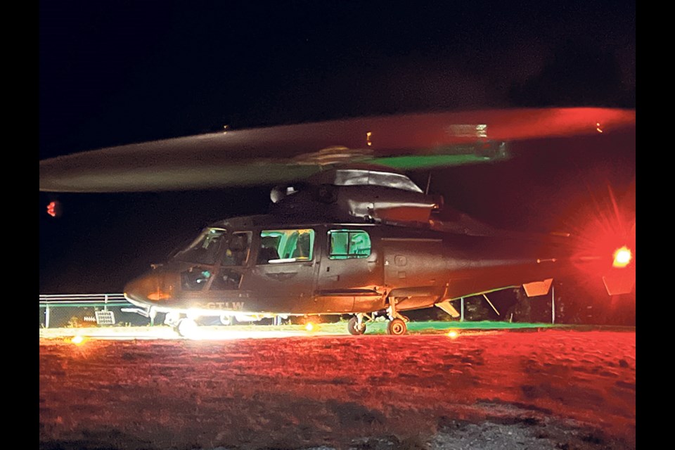 A helicopter gets ready to help in the rescue of a stranded hiker on a North Vancouver mountain Tuesday evening.