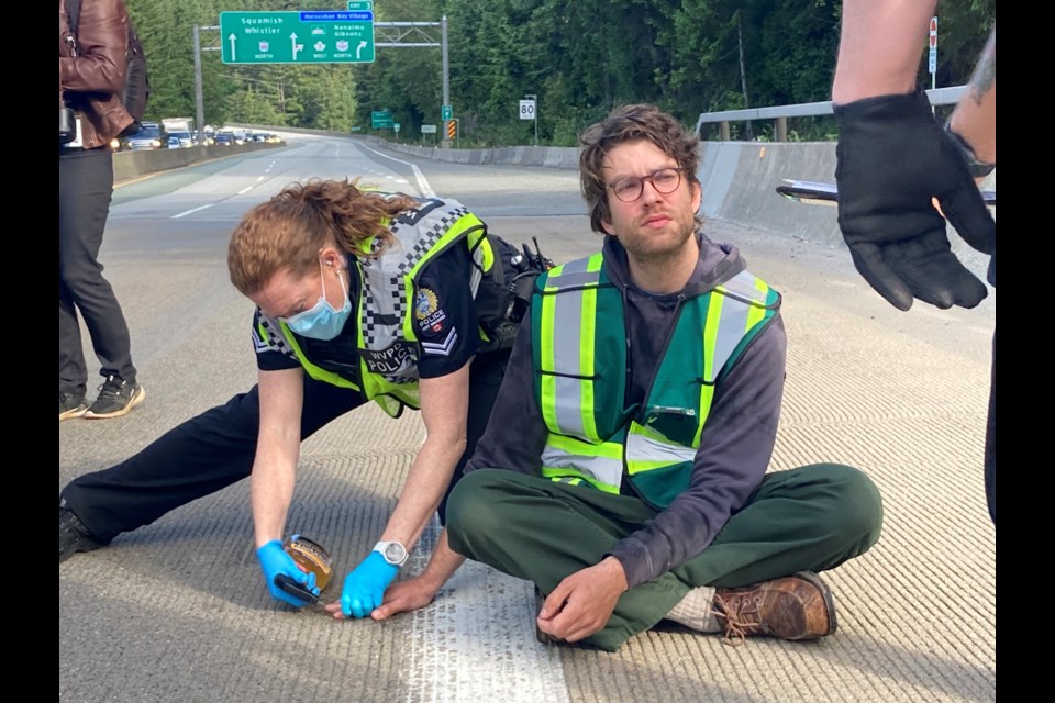Protesters from the Save Old Growth group disrupted traffic on Highway 1 near Horseshoe Bay Tuesday morning (June 14) around 8 a.m. West Vancouver Police arrested three people who had glued themselves to the road.