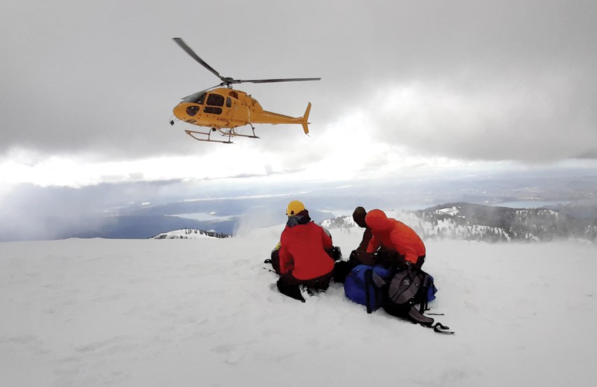 Members of North Shore Rescue prepare to airlift an injured patient from Mount Seymour after she skied into a pit dug by backcountry campers.
