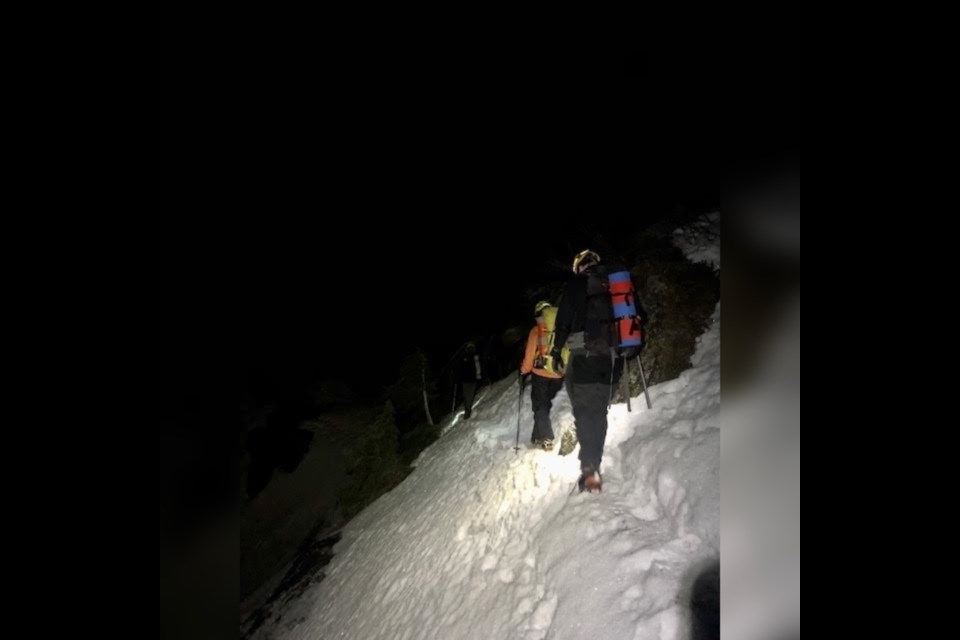 A North Shore Rescue team helps walk two lost hikers off Mount Seymour in the early hours of Dec. 3, 2021.