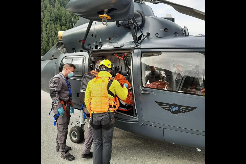 North Shore Rescue members prepare to airlift an injured senior out of the North Vancouver backcountry, May 5, 2021.