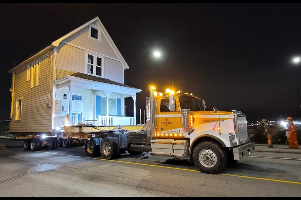 Contractors from Nickel Bros move North Vancouver's 1908 Schiplo Residence to a waiting barge,  Jan. 15, 2021.
