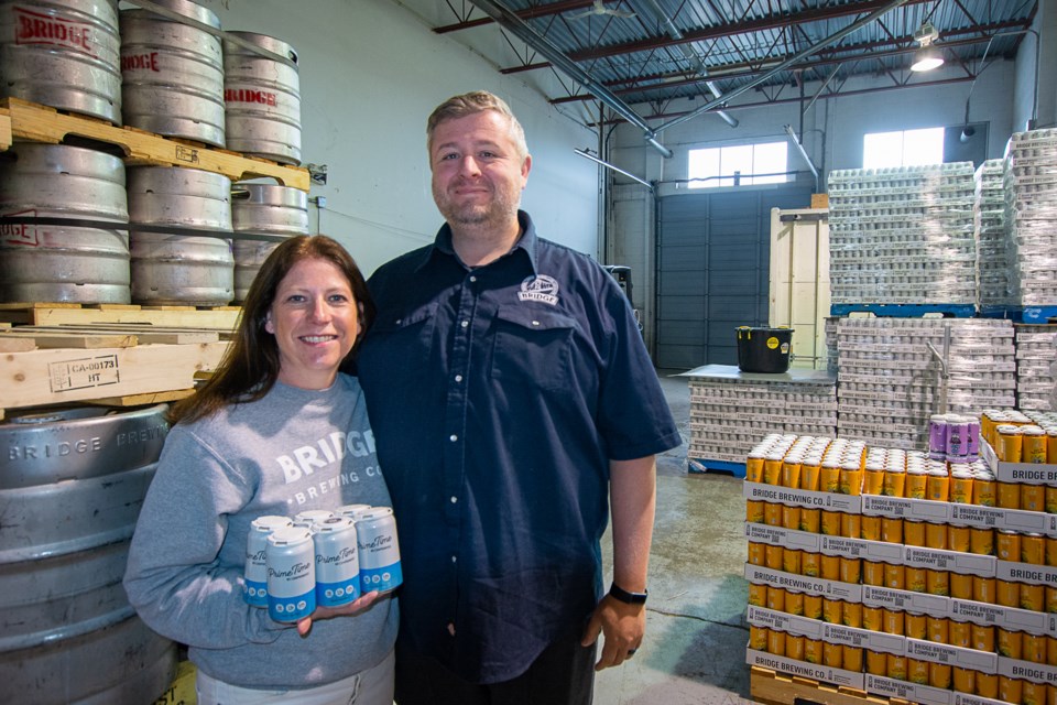 Bridge Brewing owners Leigh and Jason Stratton are currently storing flats of kegs and cans in what will become their new brewery and lounge in the Norgate neighbourhood. | Nick Laba / North Shore News 