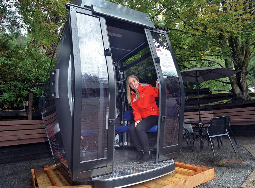 Grouse Mountain spokesperson Melissa Taylor shows off the newly proposed gondola to replace the resort's old blue tram.