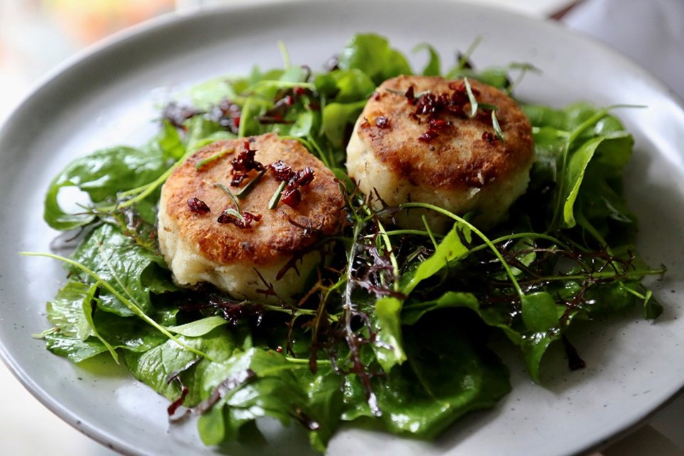 Salted Newfoundland cod and potato cakes top colourful winter greens.