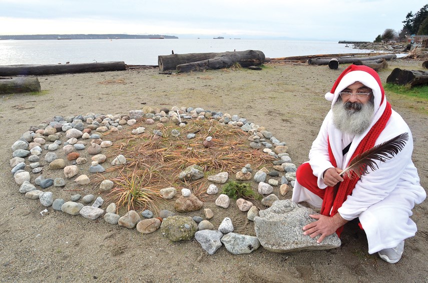 Adel Berenjian, dressed as Father Christmas, builds a heart using stones, shrubs and natural items on Ambleside Beach. Berenjian’s heart-shaped creations, a project he started three years ago to honour his daughter who passed away, have become well-known in West Vancouver, especially during the height of the pandemic. 