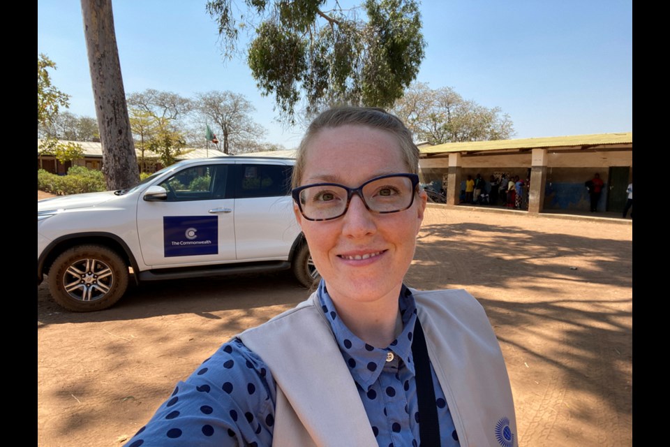 North Vancouver resident Alicia Peters documents the scene at a voting station on election day in Zambia, Aug. 12, 2021. 