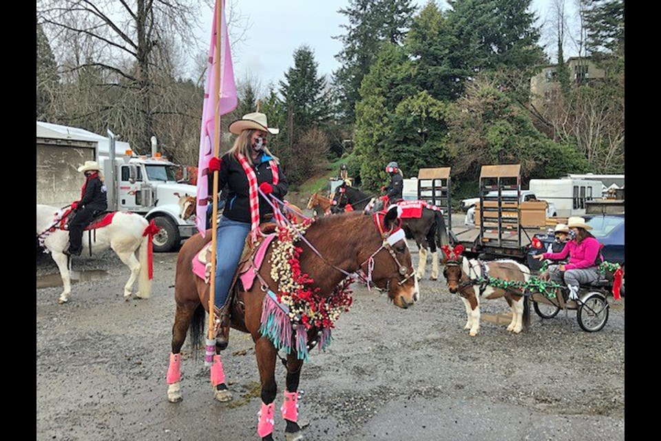 Julie MacMillan, whose father Al resides at Amica West Vancouver, prepares to lead a festive parade of horses by the care home on Sunday.
