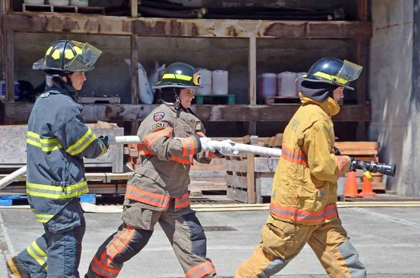 North Shore high school students Laurel Davey, Eleanor Green and Tia Harris have an opportunity to try out some of the activities they'll be doing at Camp Ignite next month, during a meet-and-greet with camp mentors held at the District of North Vancouver's firefighter training centre on July 22, 2021. 