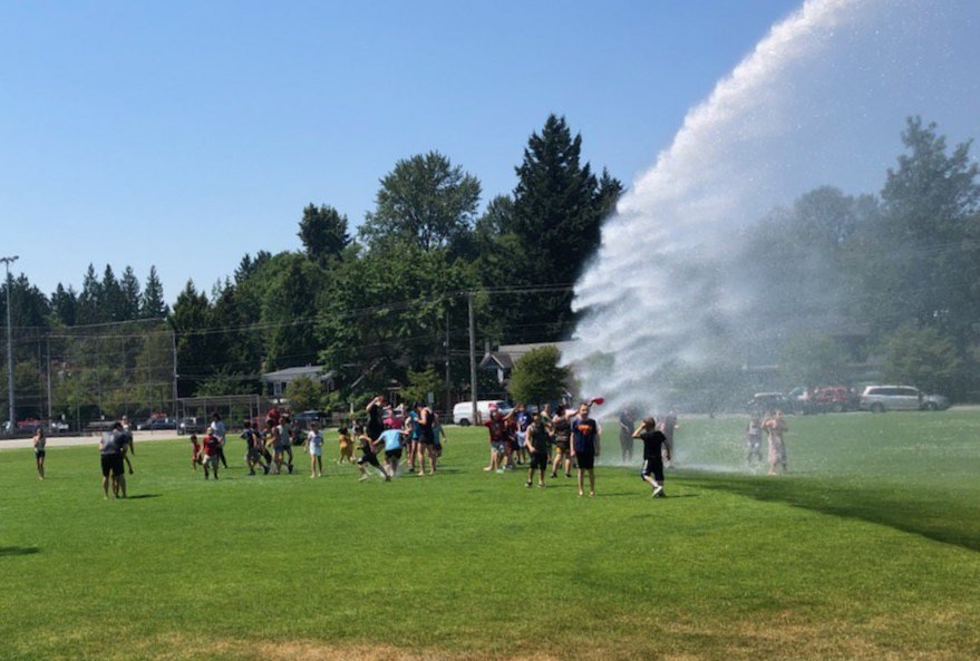 Giggles and squeals were heard at four elementary schools in North Vancouver today as students enjoyed a much-welcomed soaking by fire hoses as they ran out of class to kick off their summer break.
