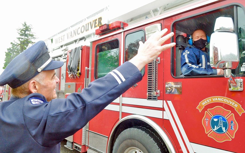 Retired firefighter William Phillips greets a parade of fire trucks in North Vancouver during the May long weekend 2021. Phillips, who is currently battling cancer, received the drive-by after his fellow firefighters decided to pay him an uplifting visit.