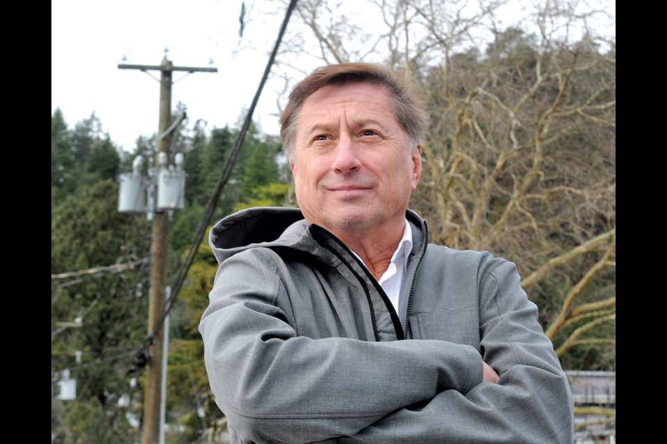 West Vancouver Mayor Mark Sager checks out the tangle of power lines in Horseshoe Bay. West Van council is exploring options for burying the power lines underground. | Paul McGrath /  North Shore News
