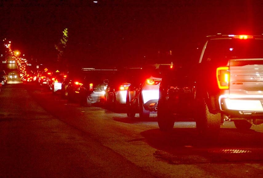 Vehicles line up along Ross Road to enter Lynn Canyon Park for the candlelight vigil in tribute to the victims of the recent stabbing attack at Lynn Valley Village.