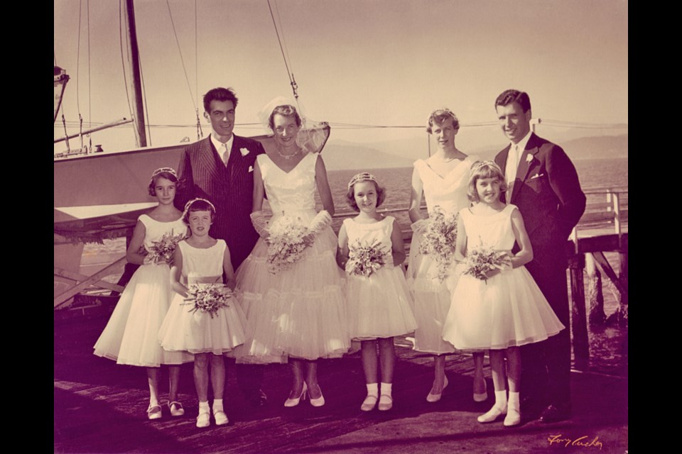 Geoff Massey and Ruth Killam on the wedding day, Sept. 21, 1955, flanked on the right by Arthur Erickson and maid-of-honour Ann Cherniavsky, plus (left-to-right) Ruthie Wilson, Carky Craig, Mia Killam, and Lib (nee Killam) Wooten; at the Royal Vancouver Yacht Club, with the shores of West Vancouver in the distance. They had just arrived by motorboat from the St. Francis-in-theWood church in TIddly Cove. 