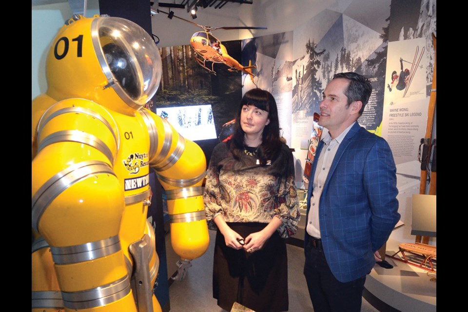 MONOVA, the  Museum of North Vancouver is opening.
Museum curator  Barbara Hilden and exhibit designer Juan Tanus of KEI Design Space check out the Exosuit display.